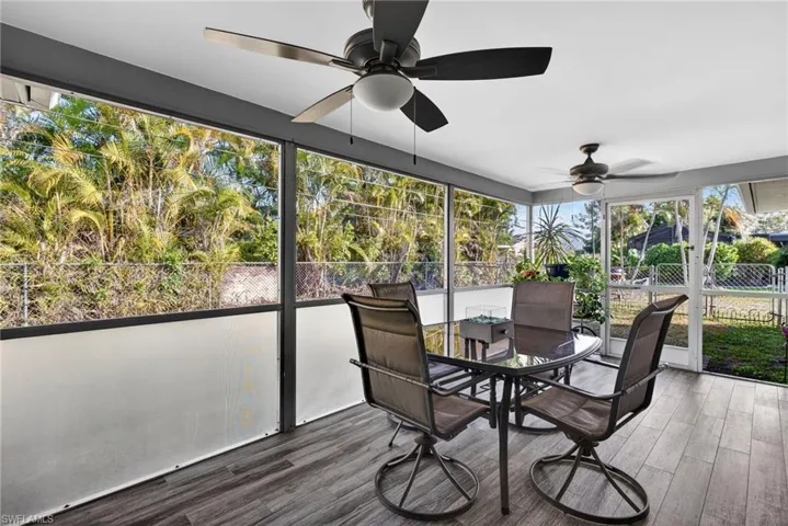 Sunroom / solarium with outdoor dining area, plenty of natural light, and a ceiling fan