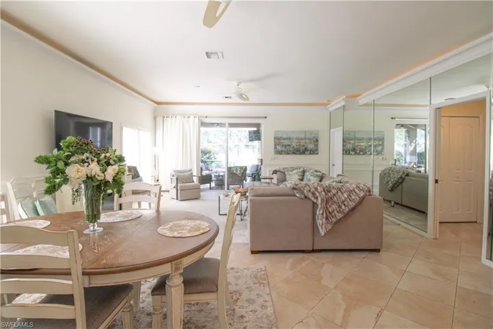 Tiled dining space featuring ceiling fan