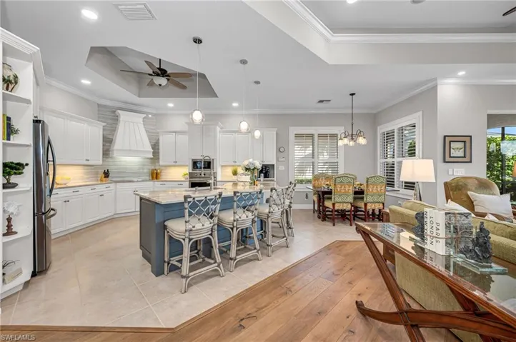 Updated chef's kitchen with Taj Mahal quartzite countertops, induction cooktop, an eat-in island for our casual, Florida lifestyle...