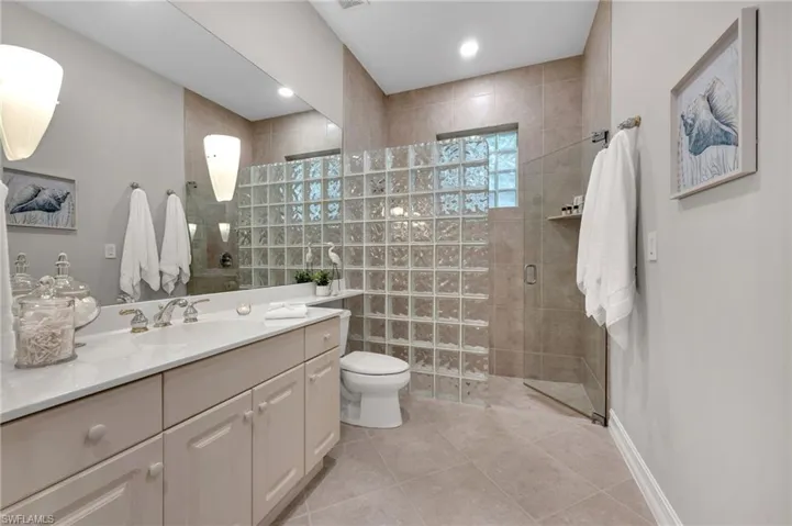 The front guest bath very large, and has an entry from both the bedroom, as well as a secondary guest bath (just in case the powder room is in use!)