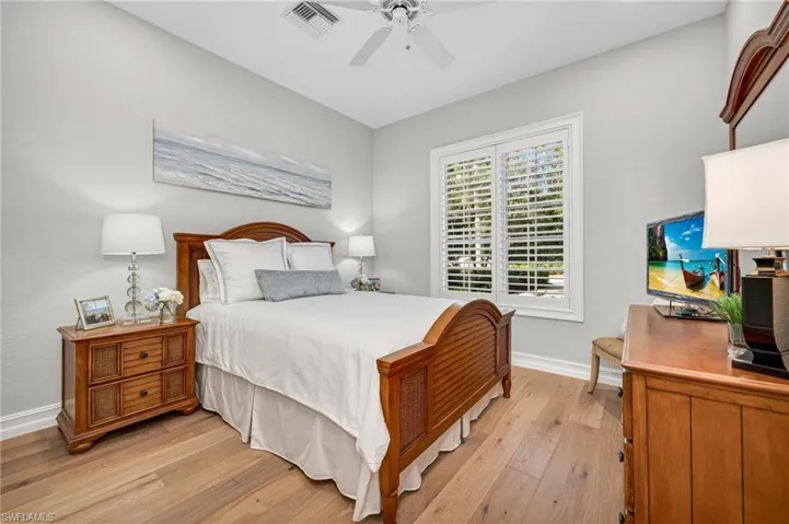 The front, ensuite guest bedroom is bright and cheery, with European Oak engineer wood floors.  All guest suites have plantation shutters on the windows.