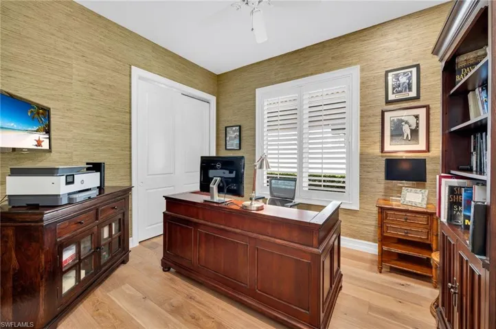 The fourth bedroom is currently being used as an office, and has been updated with European Oak engineered wood floor and has timeless, woven wallpaper for decor.