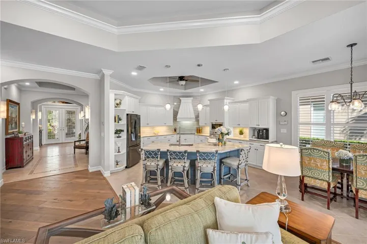 This unique floor plan truly has it all, from an open kitchen to the dinette area, to the large, custom bar, and guest rooms beyond.