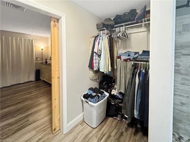 Walk in closet featuring wood finished floors