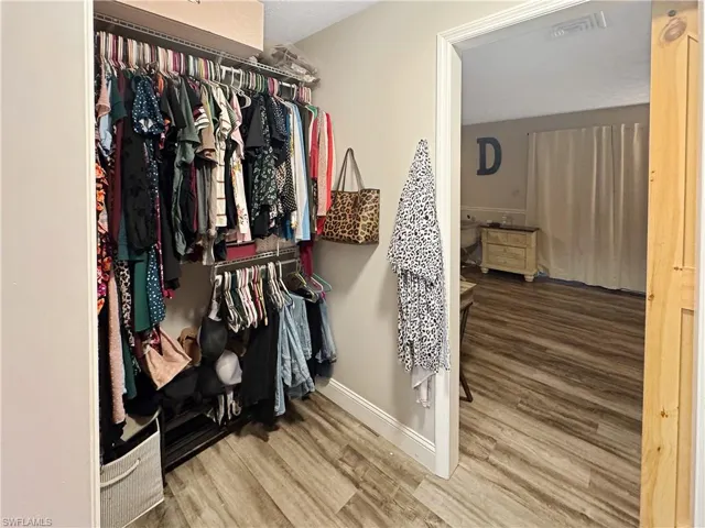 Spacious closet with light wood-style floors