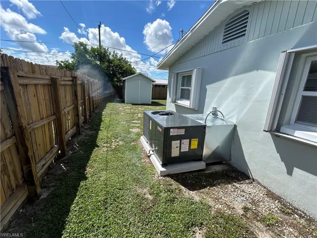 View of yard featuring a shed and central AC unit