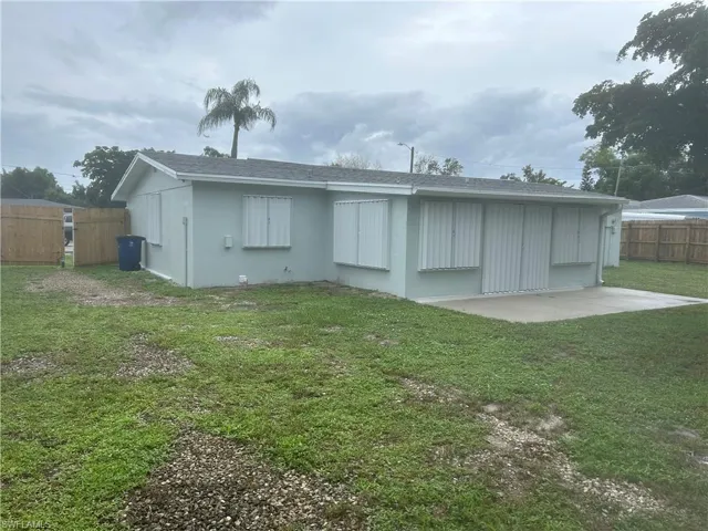 Back of house with a yard and a patio area