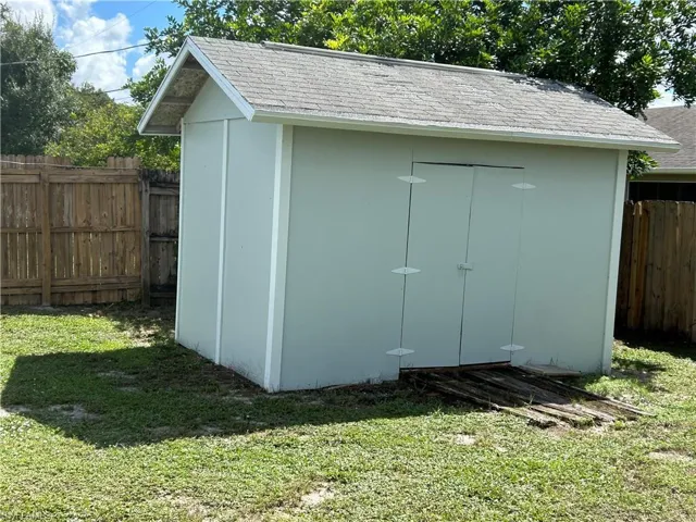 View of outdoor structure with a yard