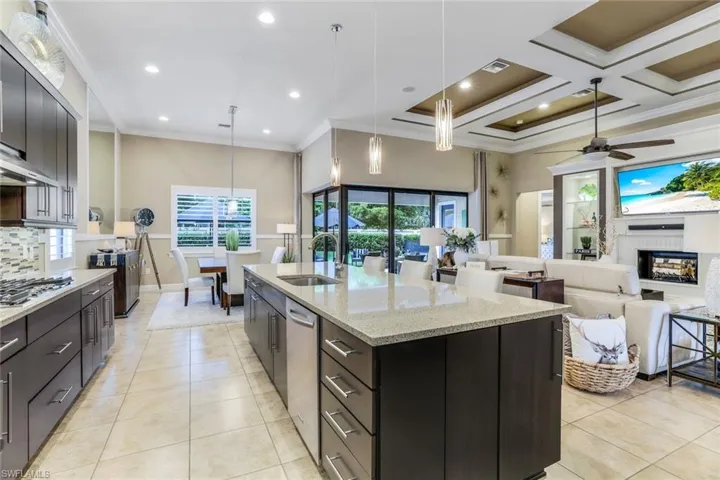 Heart of the home gourmet kitchen featuring natural gas with a 10' kitchen island with sink, pendant lighting and sink