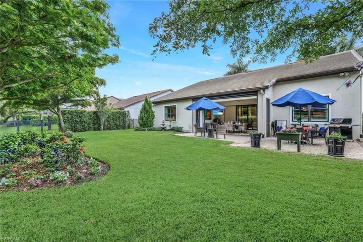View of large, private yard featuring a patio and large, completely fenced in yard.  Plenty of room to customize an oasis of your dreams or simply enjoy the expansiveness and beautiful existing shade trees.