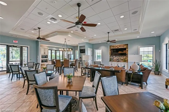 Light and bright community clubhouse featuring kitchen, sitting area and dining space