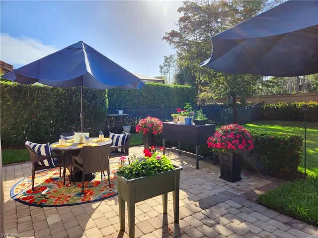 View of backyard private extended paver lanai