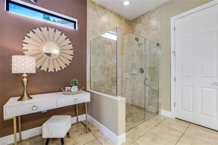 Owner's Bathroom with tile flooring and a shower with frameless door