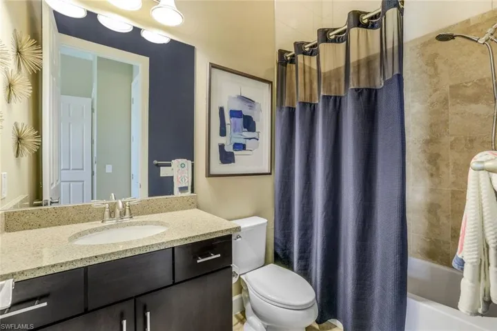 Full ensuite bathroom with shower / bath combination, toilet, and oversized vanity