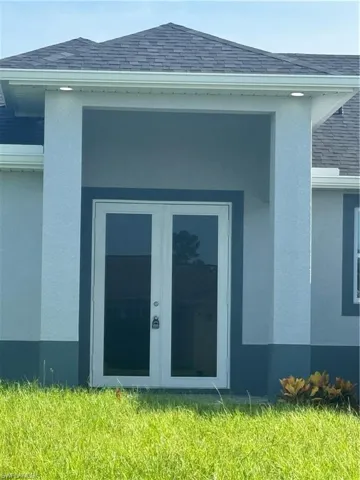 View of side of property with a lawn
