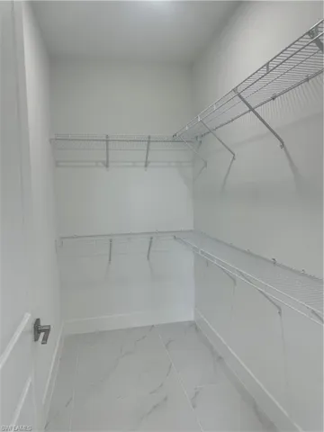 Walk in closet with tile patterned flooring