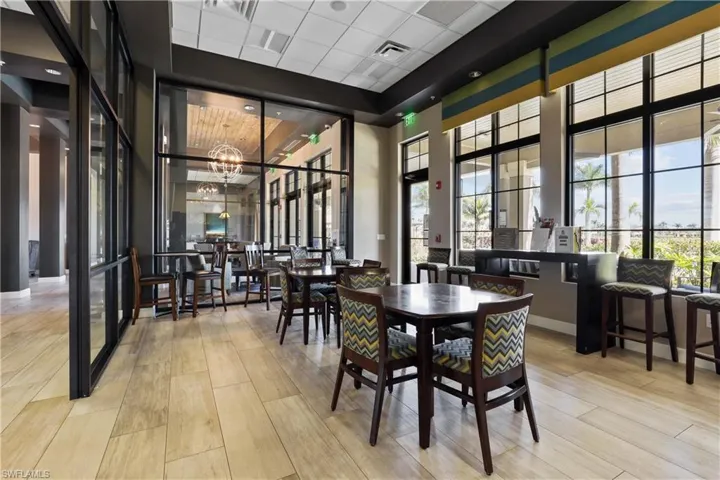 Dining room featuring a high drop ceiling, light wood-style floors, and a chandelier