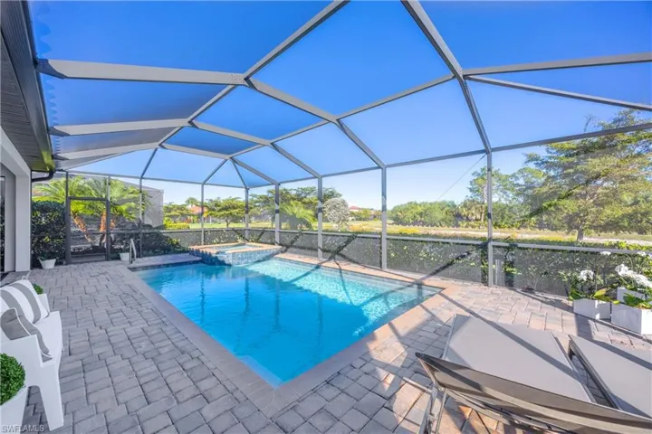 Integrated pool / spa featuring a sunroom, a patio, and a lanai