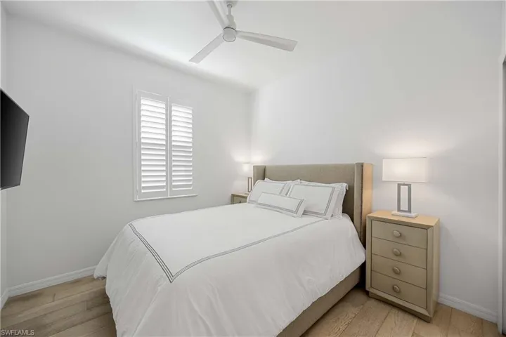 Bedroom with light wood-style floors and ceiling fan