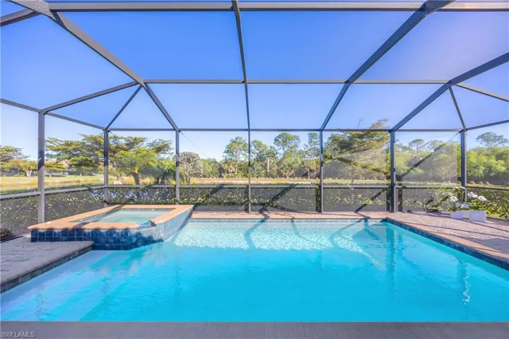 Combined pool / hot tub featuring a sunroom and a lanai