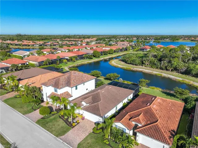 Aerial view of residential area featuring a nearby body of water