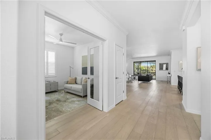 Hall featuring crown molding and light wood-style flooring