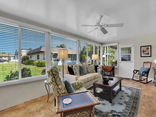 Living room featuring healthy amount of natural light and ceiling fan