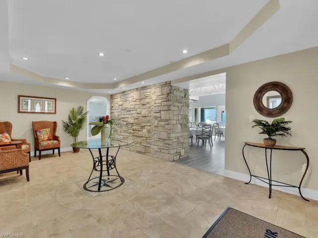 Sitting room with recessed lighting, a tray ceiling, and baseboards