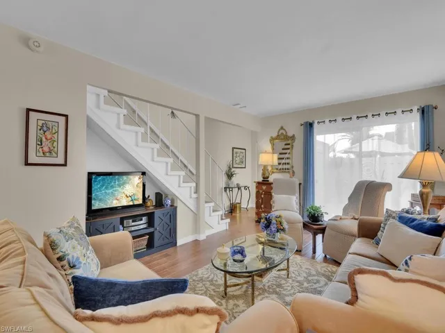 Living area with wood finished floors and stairs