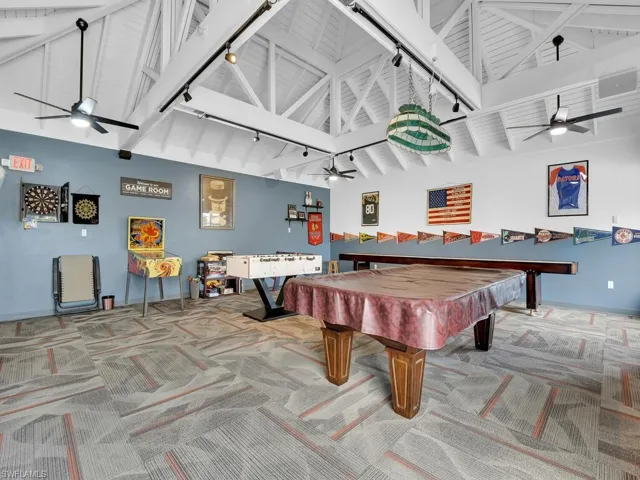 Game room with ceiling fan, rail lighting, and carpet flooring