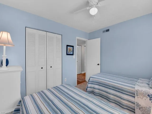 Bedroom with a closet, baseboards, ceiling fan, and carpet floors