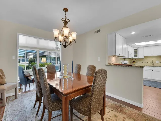 Dining space with a chandelier, light wood-style flooring, baseboards, and recessed lighting