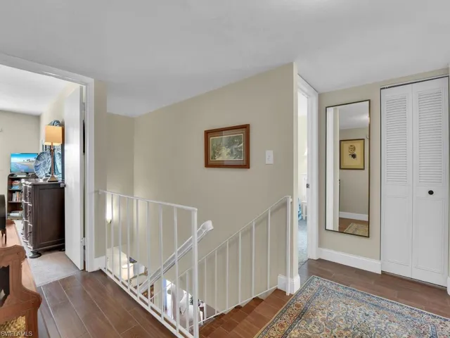 Stairs featuring wood finished floors and baseboards