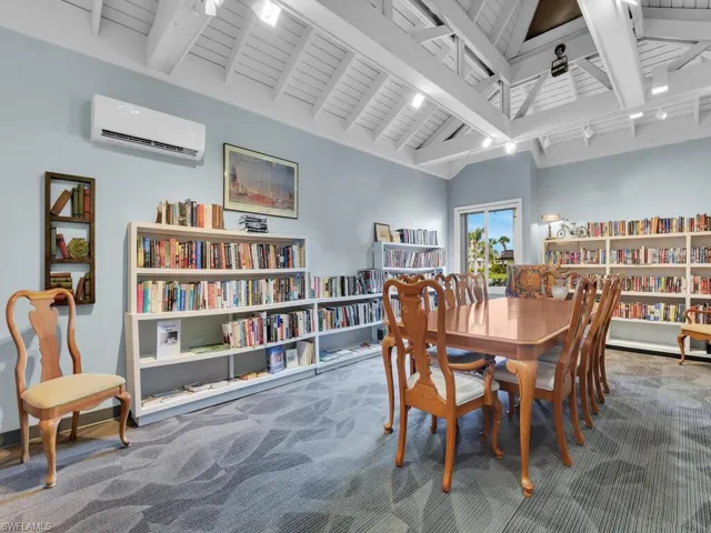 Carpeted dining area featuring a wall unit AC