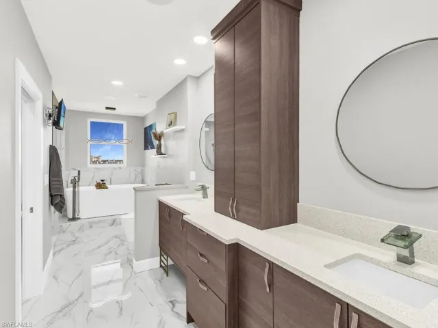 Bathroom featuring a bathing tub and vanity