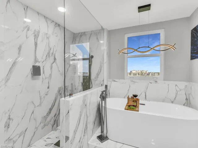 Bathroom featuring plus walk in shower and tile walls