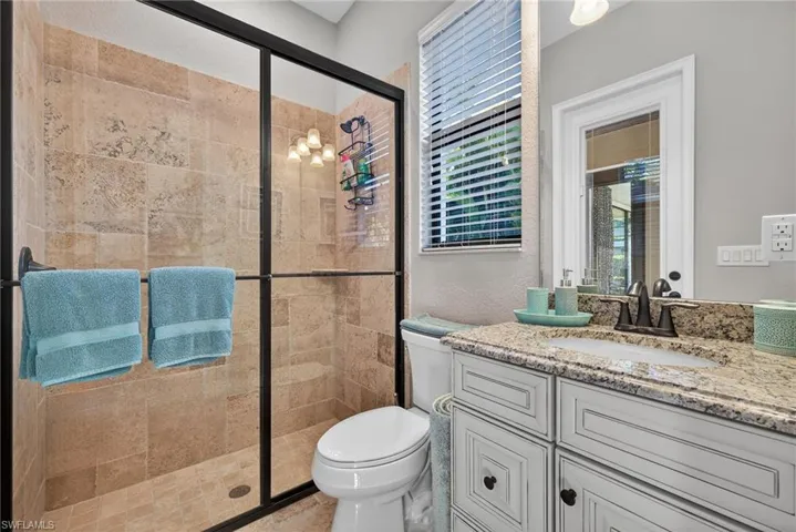 Full bathroom featuring a shower stall and vanity