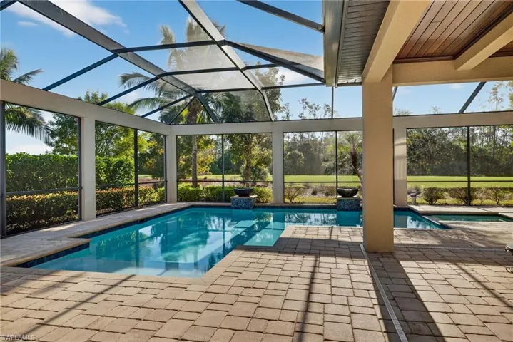 Outdoor pool with a sunroom, a lanai, and a patio