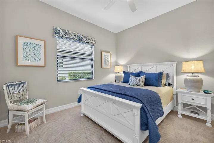 Bedroom with light colored carpet and a ceiling fan