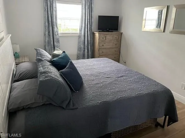 Bedroom featuring baseboards and wood finished floors