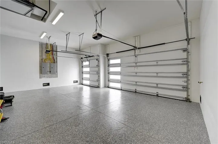Garage with electric panel and a garage door opener