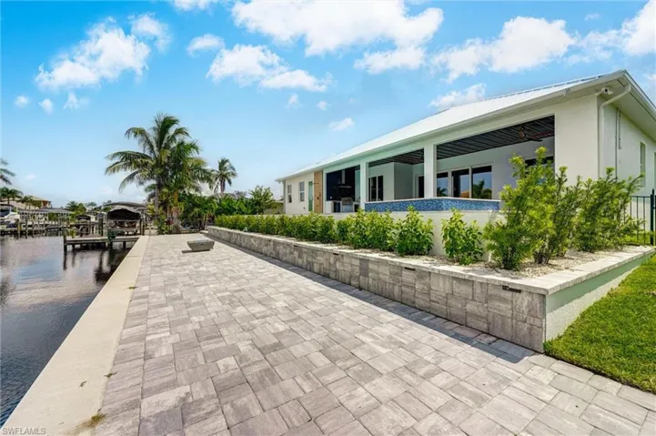 Surrounding community featuring a water view and a boat dock