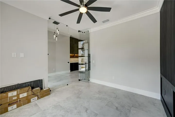 Unfurnished room with ornamental molding and a ceiling fan