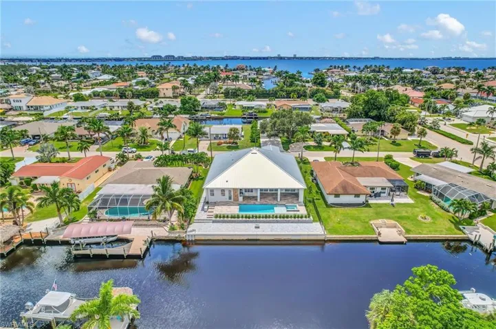 Aerial perspective of suburban area featuring a large body of water