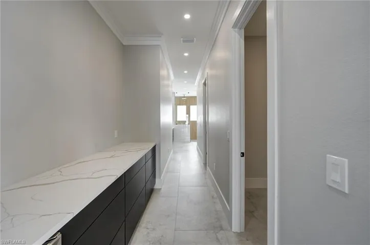 Hallway featuring recessed lighting and crown molding