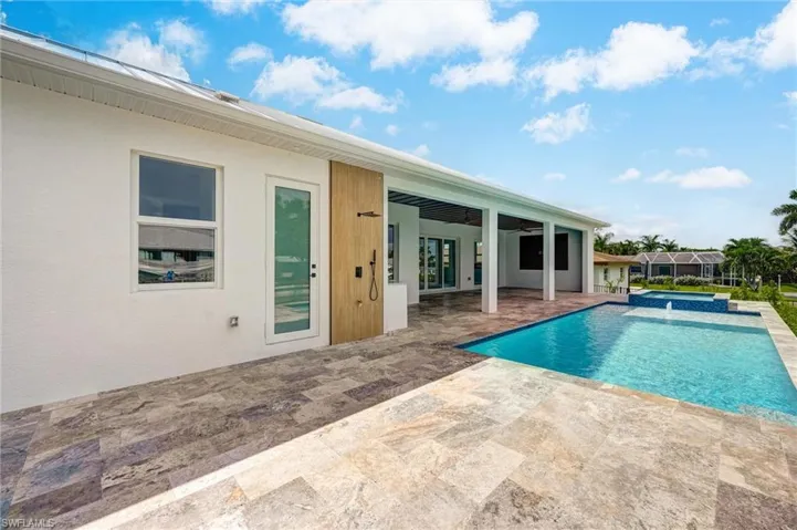View of swimming pool with a pool with connected hot tub and a patio area