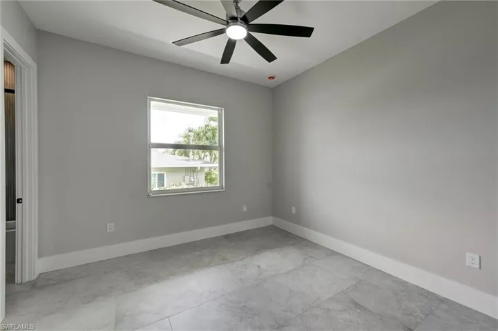 Bedroom 2 with baseboards and ceiling fan