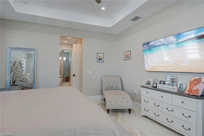 Bedroom featuring a tray ceiling, recessed lighting, and a ceiling fan