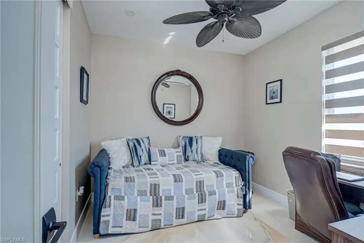 Bedroom featuring ceiling fan and baseboards