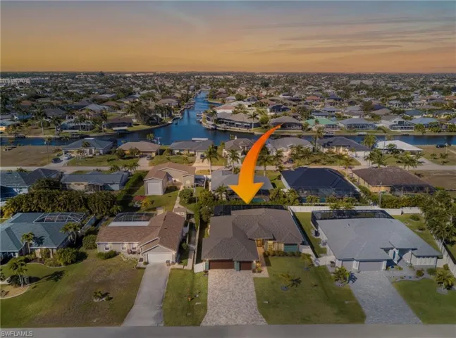 Aerial overview of property's location featuring a nearby body of water and nearby suburban area
